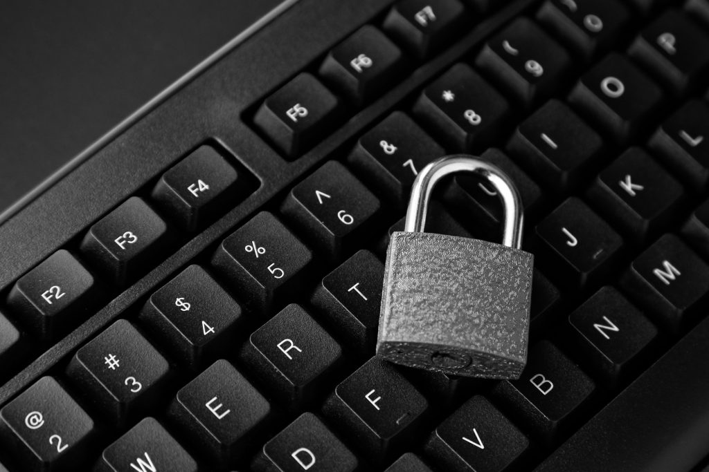 High angle shot of a lock on a black computer keyboard