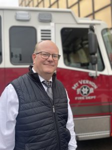 President of IDS Applications standing by a firetruck in Mt Vernon, IL